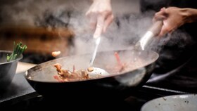 Mâncare la gătit într-un wok pe o plită cu inducție AEG